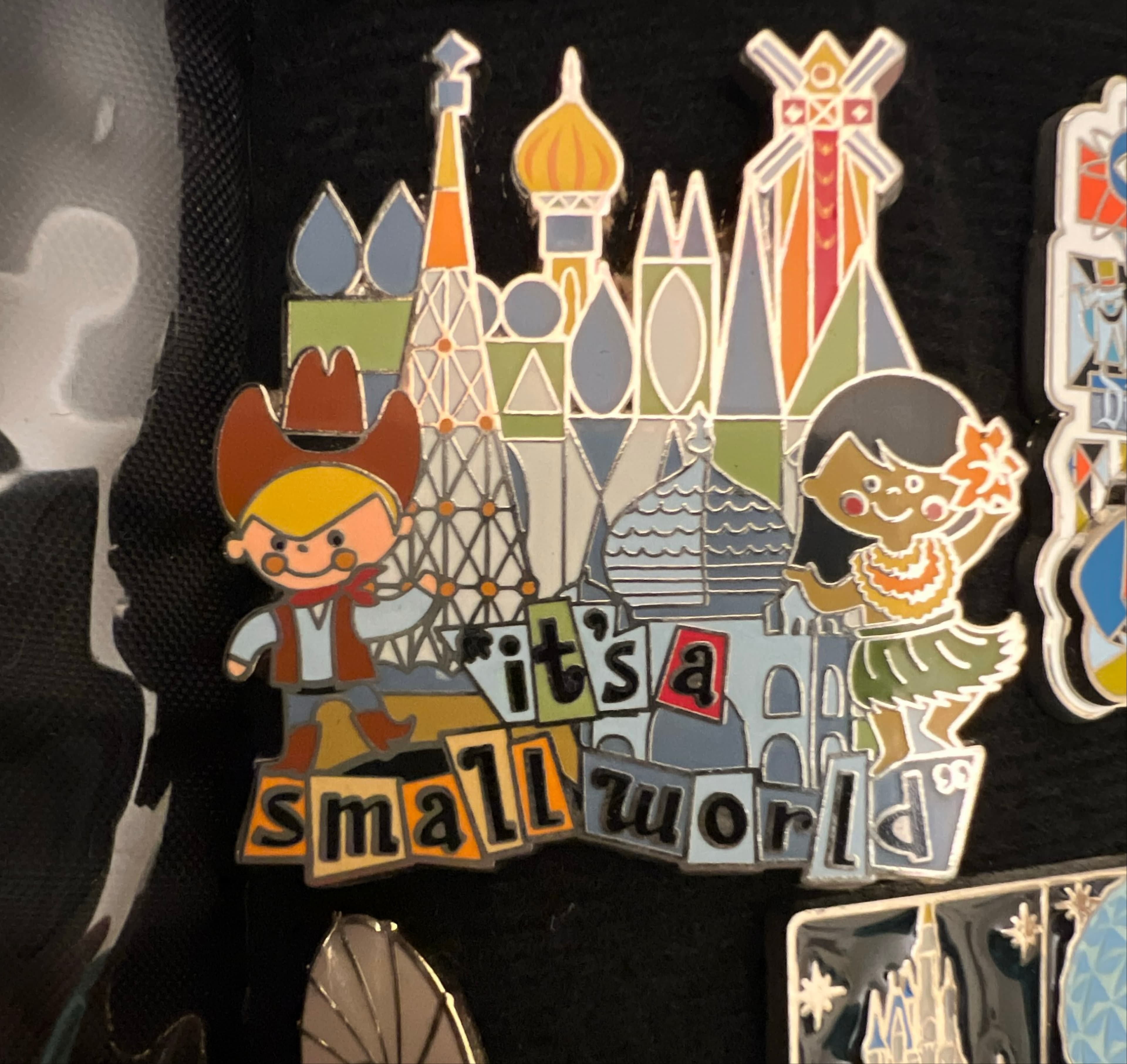 It's a Small World Cowboy and Hula Girl with Buildings Pin