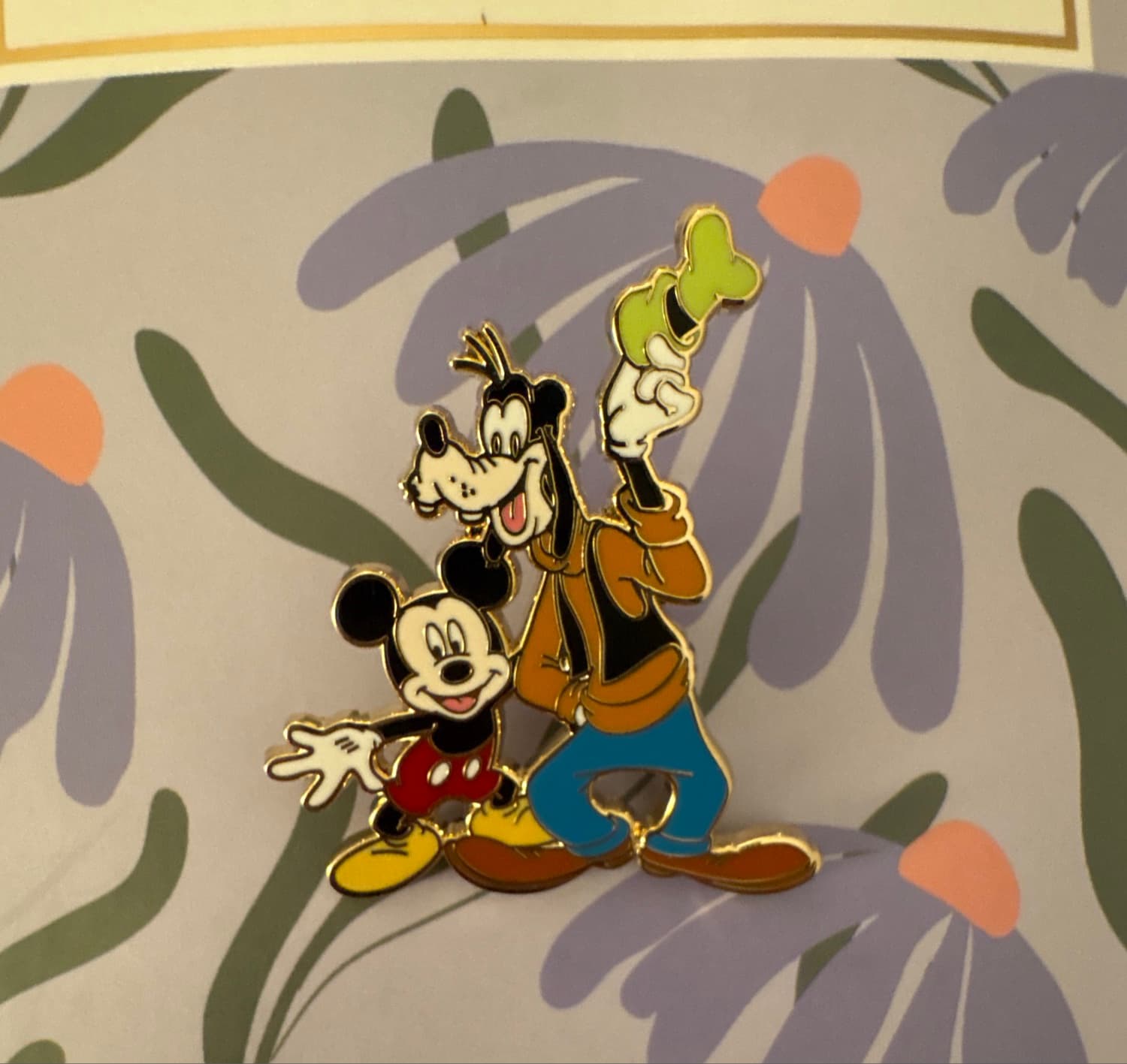 Mickey Mouse Crouching and Goofy Holding Hat