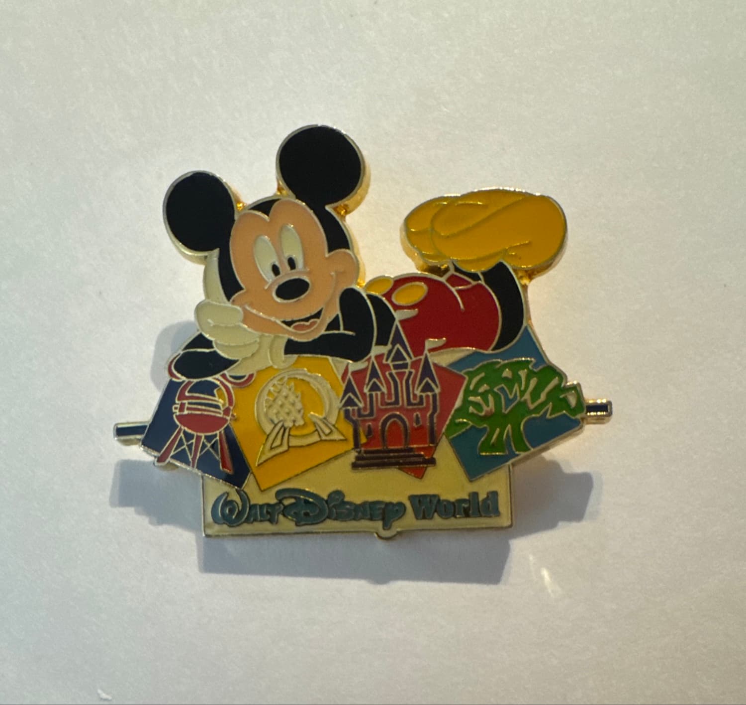 Mickey Mouse Lying on Walt Disney World Four Park Logos Pin
