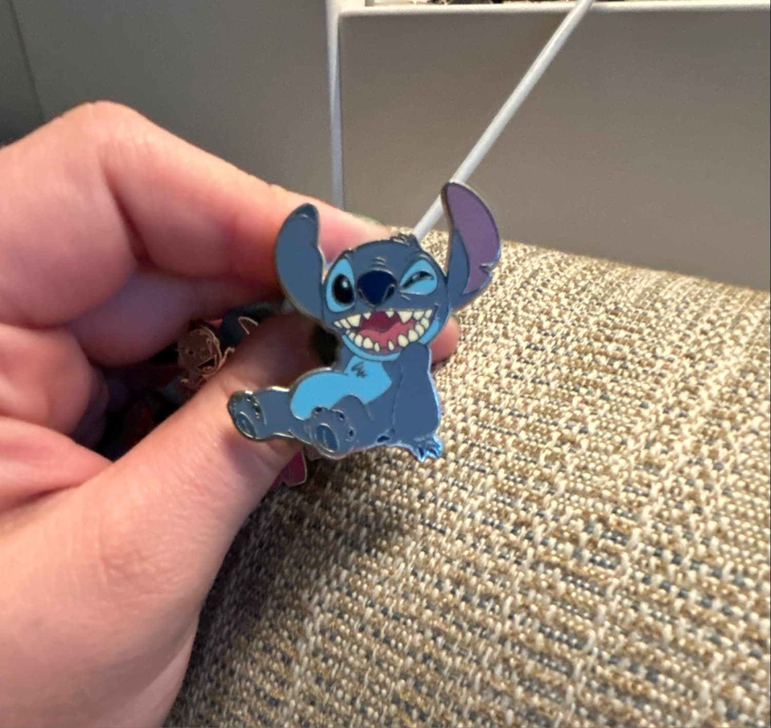 Stitch Sitting, Smiling, and Winking Lanyard Pin