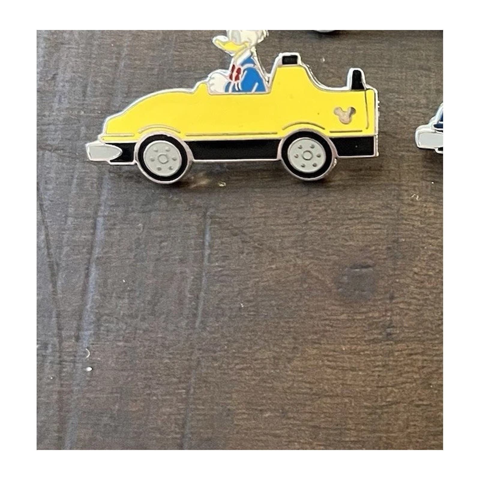 Donald Duck Driving a Yellow Car front