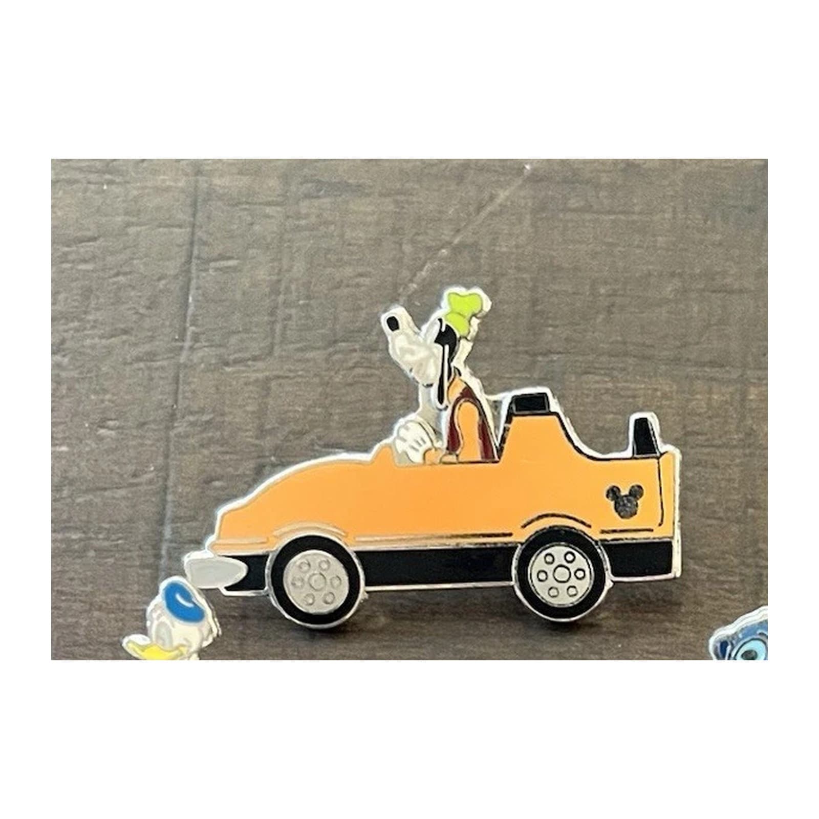 Goofy Driving an Orange Car