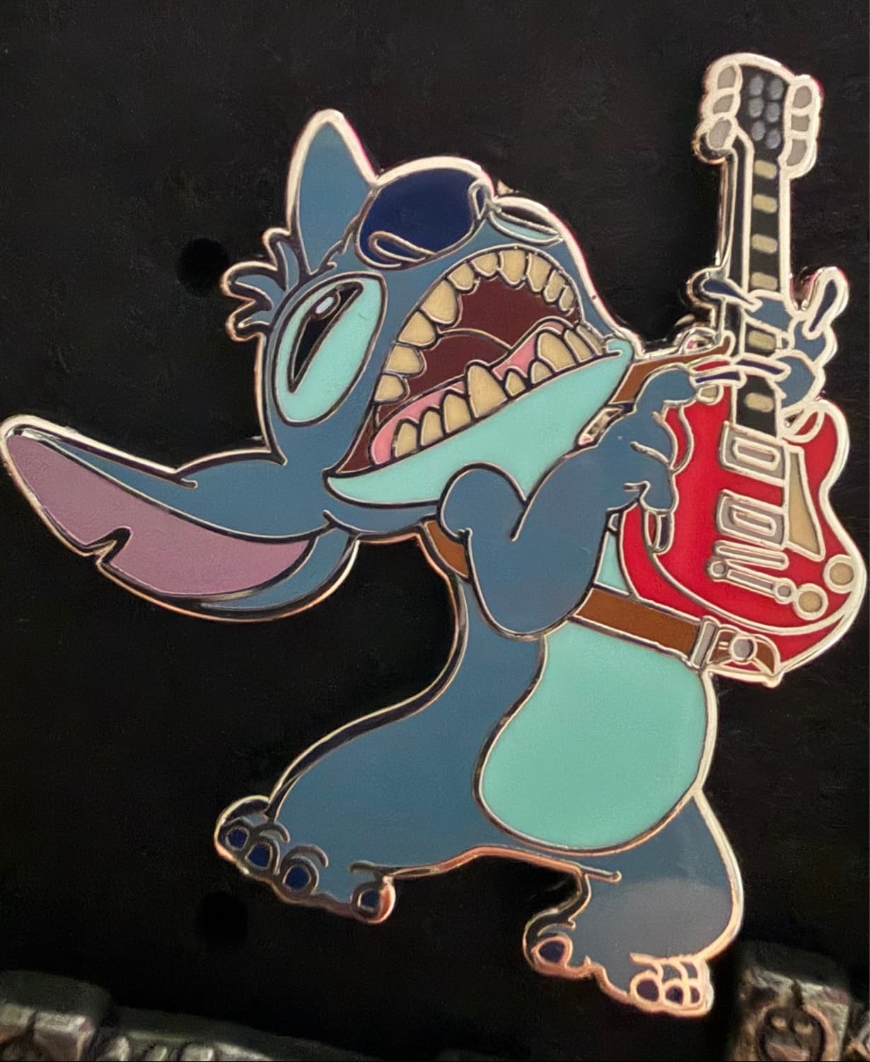Stitch playing a guitar