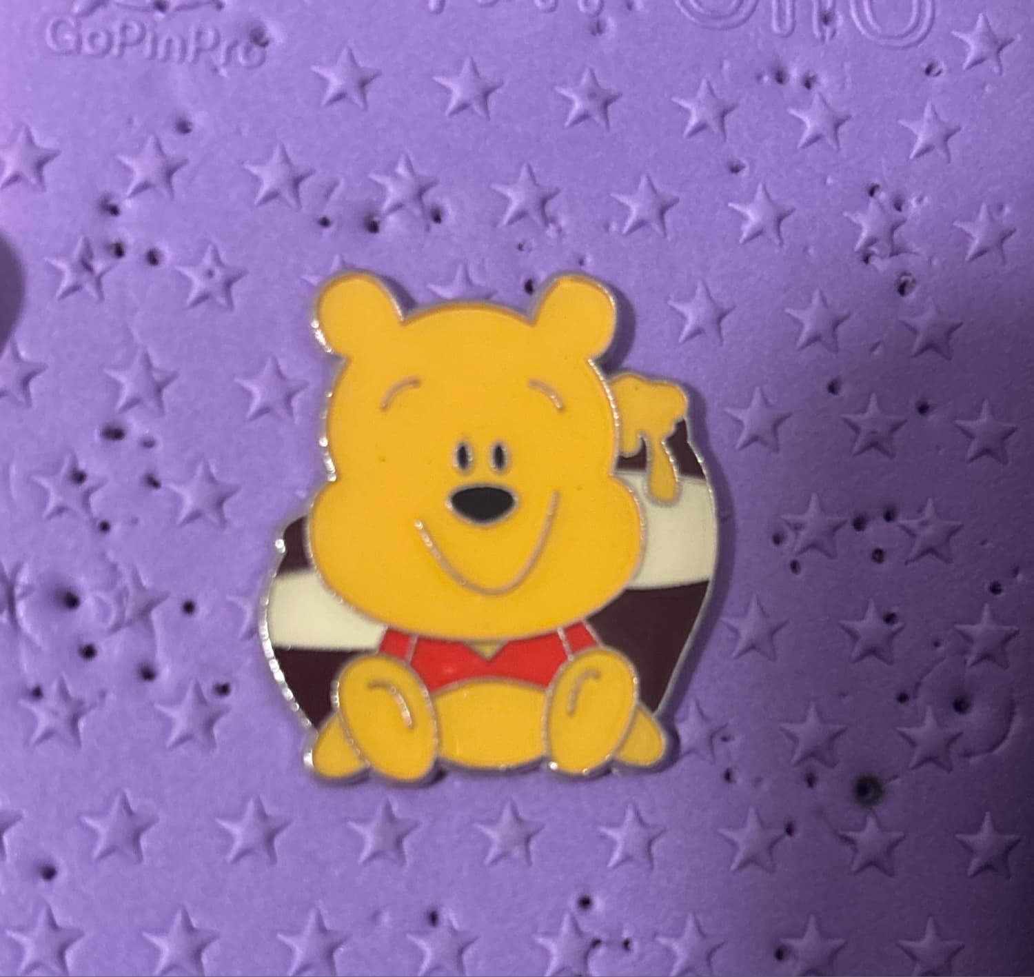 Pooh sitting with "Hunny" honey pot